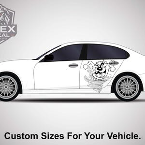 May include: White car with a black and white Tazmanian Devil decal on the side. The cartoon character is depicted in a swirling tornado. The text "Custom Sizes For Your Vehicle" is at the bottom of the image.