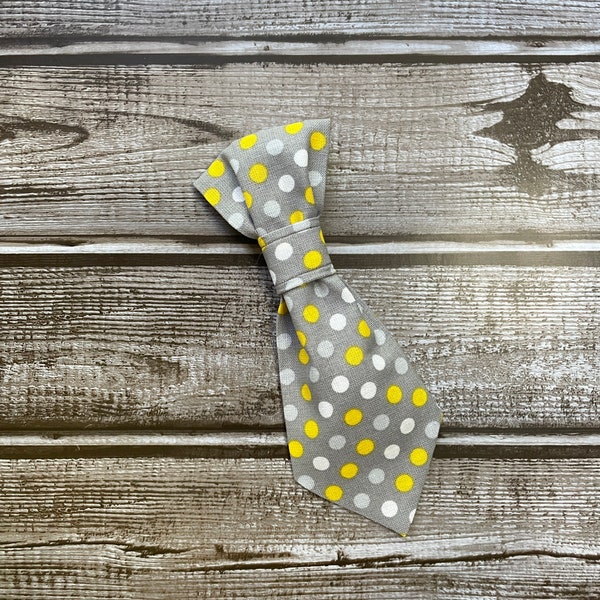 Yellow and white polka dots on a grey background cat or dog necktie, that slides on a collar.