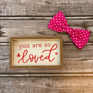 Bright pink with white polka dots dog or cat bow, slides on collar.