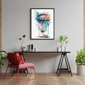 May include: A watercolor painting of a colorful umbrella with drips of paint, a glass of water with a slice of watermelon, and a green leaf. The painting is framed in a black frame and hanging on a white wall.