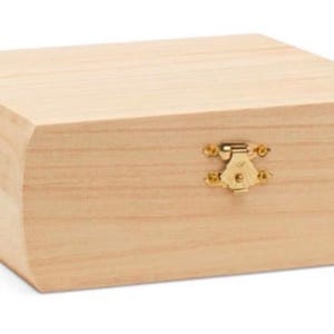 May include: A natural wood box with a hinged lid and a brass latch. The box is unfinished and ready to be painted or stained.