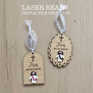 May include: Two wooden ornaments with the text "Jesus watches over me" and a small Jesus figure. One is arched, the other is oval with a scalloped edge. Both have a cross at the top and are attached to a white ribbon.