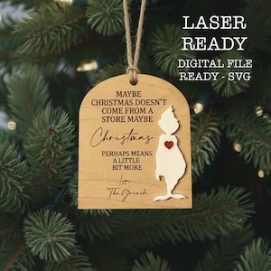 May include: Wooden Christmas ornament featuring a Grinch design and the text "Maybe Christmas doesn't come from a store maybe Christmas perhaps means a little bit more." Includes a jute string for hanging.