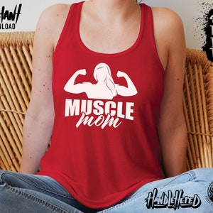 May include: Red tank top with a white silhouette of a woman flexing her muscles and the text "MUSCLE MOM".