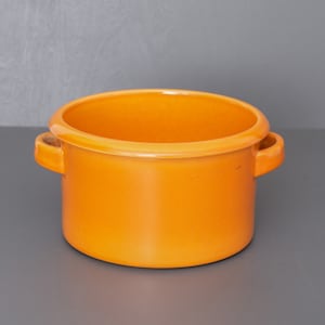 May include: Orange ceramic pot with two handles. The pot is round and has a smooth, glossy finish.