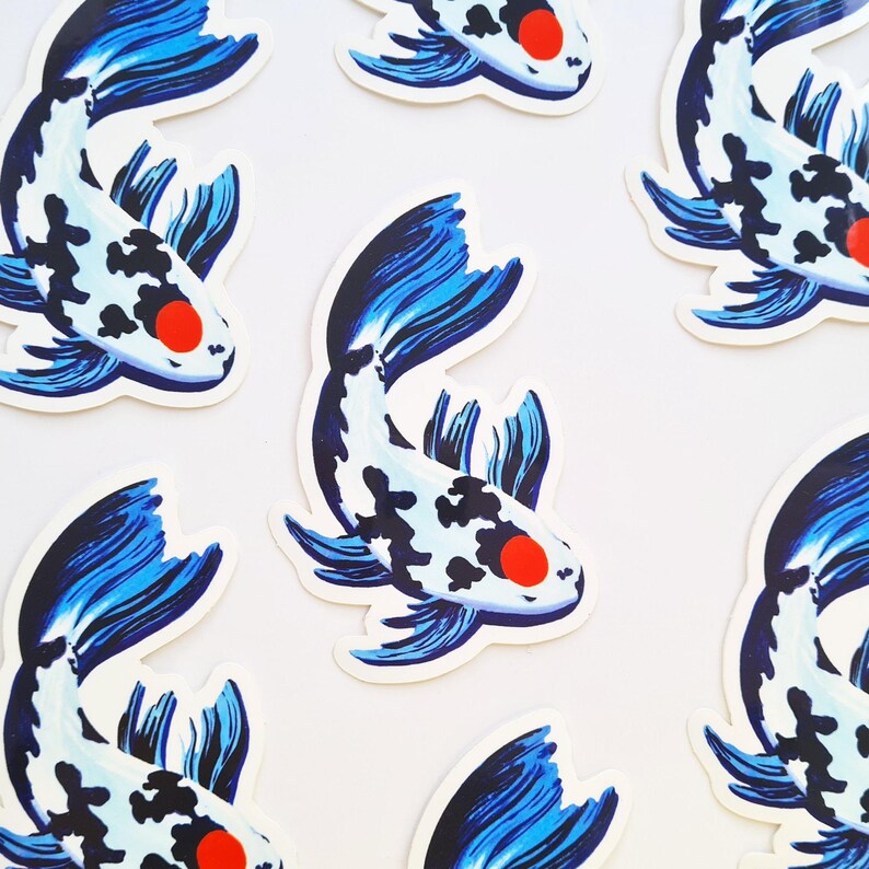 May include: A collection of stickers featuring a koi fish design. The fish have a white body with black spots, blue fins and tail, and a red eye. The stickers are arranged on a white background.