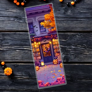 May include: A Halloween-themed bookmark featuring a storefront with a door and windows decorated with pumpkins, lights, and fall foliage. The storefront is set against a backdrop of a purple sky with stars.