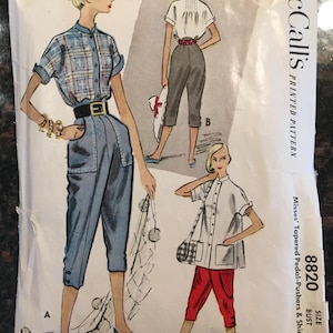 May include: Vintage McCall's sewing pattern for a women's shirt and pedal pushers. The pattern is for size 14, bust 32, and is printed on white paper with a black and white illustration of a woman wearing the outfit. The pattern number is 8820.