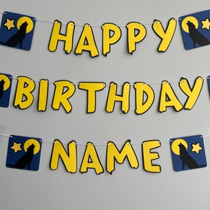 May include: A yellow and black banner with the words "Happy Birthday NAME" and wolf silhouettes on a blue background.