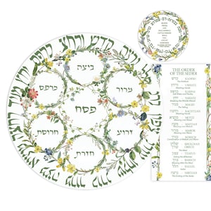 May include: A white Passover Seder plate with floral designs and Hebrew text. The plate is surrounded by a floral wreath and includes sections for traditional Seder foods. A smaller circular plate and a card with English text are also included.
