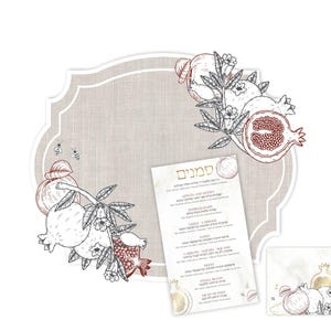 May include: A beige, scalloped-edge card with a linen texture, decorated with line-art illustrations of pomegranates and bees. A smaller rectangular card features the Hebrew title Simanim and a list of foods in English and Hebrew text.