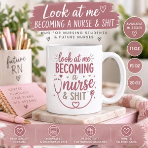 May include: A white ceramic mug featuring the dark pink text 'look at me BECOMING A nurse & SHIT' with a stethoscope graphic. The design includes small heart accents. The mug is displayed with a matching pen holder and a notebook.