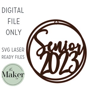 May include: A brown circle with a double outline, containing the text "Senior 2023" in a stylized font.