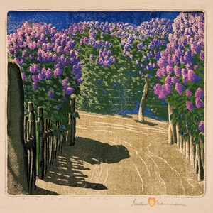 May include: A colorful print of a path lined with blooming lilac bushes. The artwork features a path leading into the distance, bordered by wooden fences and lush purple flowers. The sky is a deep blue, and the scene is bathed in sunlight.