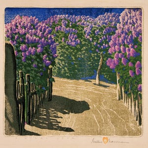 May include: A colorful print of a path lined with blooming lilac bushes. The artwork features a path leading into the distance, bordered by wooden fences and lush purple flowers. The sky is a deep blue, and the scene is bathed in sunlight.