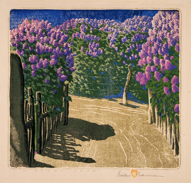 May include: A colorful print of a path lined with blooming lilac bushes. The artwork features a path leading into the distance, bordered by wooden fences and lush purple flowers. The sky is a deep blue, and the scene is bathed in sunlight.