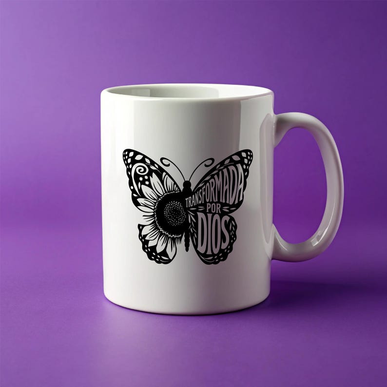 May include: White ceramic coffee mug with a black butterfly design. The butterfly has a sunflower in its wings and the text "TRANSFORMADA POR DIOS" written on its wings.