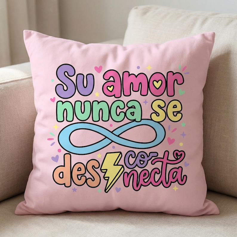 May include: A pink decorative pillow with the Spanish text "Su amor nunca se desconecta" in colorful bubble letters. The design includes hearts, stars, an infinity symbol, and a lightning bolt.