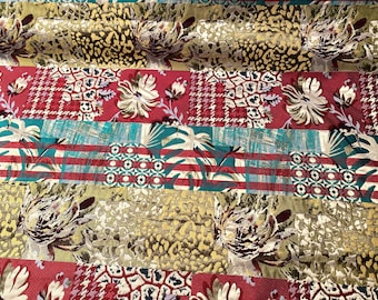 May include: A patchwork textile with diverse patterns and colours. The design incorporates sections with floral prints, houndstooth, leopard spots, and stripes in shades of red, green, gold, and white. The fabric has a textured, possibly woven, surface.