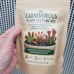 May include: A tan pouch of Carnivorous Plant Culture Mix featuring a label with illustrations of Venus flytraps, pitcher plants, and sundews. The text reads Carnivorous Plant Culture Mix, Specially blended for Venus Flytraps, Pitcher Plants, Sundews, and other carnivorous species, Propagation & Planting Blend for Carnivorous Plants, Peat-Free, Acidic, Root-Supporting, and www.forestorganics.net.