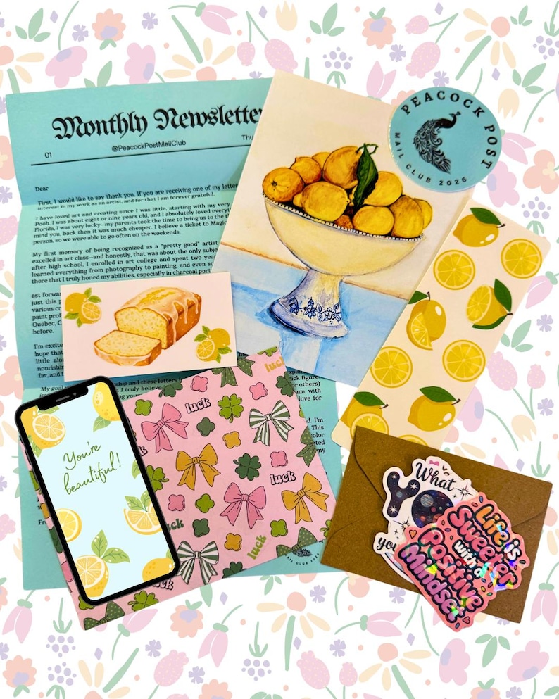 May include: A collection of stationery items with a floral background. Includes a newsletter, stickers, a phone displaying "You're beautiful!", and cards with lemon and bow designs. A bowl of lemons is also featured.