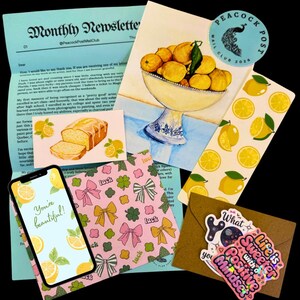 May include: A collection of stationery items featuring a lemon theme. Includes a newsletter, a watercolor painting of lemons in a bowl, stickers, a phone displaying the text "You're beautiful!", and patterned paper.