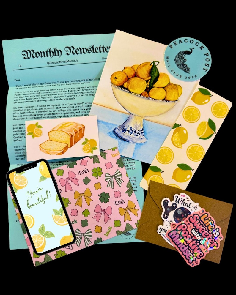May include: A collection of stationery items featuring a lemon theme. Includes a newsletter, a watercolor painting of lemons in a bowl, stickers, a phone displaying the text "You're beautiful!", and patterned paper.
