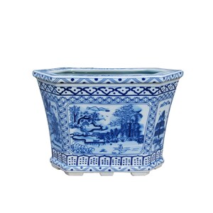 May include: A white ceramic planter with a blue and white floral design. The planter is octagonal in shape and has a wide, flat base.