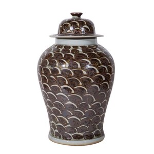 May include: A brown and white ceramic ginger jar with a lid. The jar is decorated with a pattern of overlapping brown scales.