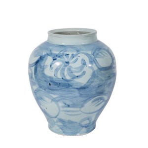 May include: A ceramic vase with a round body and a light blue rim. The vase is decorated with a blue floral pattern. The vase is a decorative item.