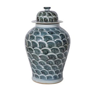 May include: A large, blue and white ceramic jar with a lid. The jar is decorated with a repeating pattern of overlapping, stylized waves.