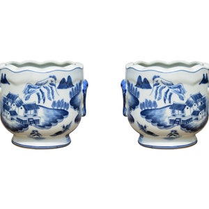 May include: Two white ceramic planters with blue and white painted designs of a Chinese landscape. The planters have a scalloped rim and two small handles on each side.