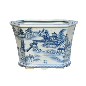 May include: A large, octagonal ceramic planter with a blue and white landscape design. The planter features a detailed scene of pagodas, bridges, and trees. The planter is approximately 12 inches wide and 8 inches tall.