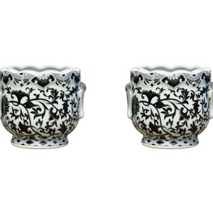 May include: Two white ceramic planters with black floral designs and lion head handles.