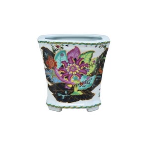 May include: A white ceramic planter with a square base and a floral design. The design features a large pink flower with green leaves and black accents.