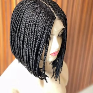 May include: A black braided wig with a lace front. The wig is styled in a bob with straight braids.