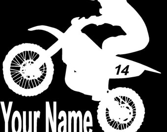 May include: White silhouette of a motocross rider on a dirt bike with the number 14 on the side. The text "Your Name" is below the bike.