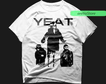May include: White t-shirt with a black and white graphic print of three people. The text "YEAT" is printed in black at the top of the shirt.