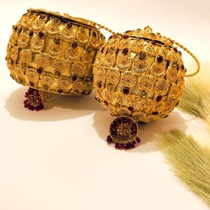 Elegant and fancy clutch/purse with top handle. Alloy Metal Round/Potli clutches/purses for girls and Ladies.