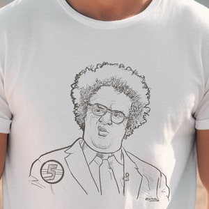 May include: A white t-shirt with a black and white line drawing of a man with an afro wearing a suit and tie. The man is wearing a microphone and has a number "5" on his jacket. The text "@jon_habda" is at the bottom of the image.