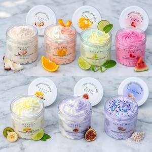 May include: An assortment of whipped soap scrubs in clear jars with white lids. Flavors include Coconut Bliss, Orange Dreamsicle, Sunshine, Watermelon Sugar, Banana Split, Figgy Cream, and Sel de Mer. Each jar is decorated with fruit and herbs.