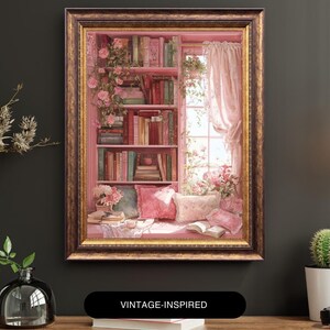 May include: A framed painting of a cozy reading nook. The artwork depicts a pink bookshelf filled with books, a window with sheer curtains, and a window seat with pillows. Roses and other flowers adorn the scene. The frame is gold. Text on the bottom reads "VINTAGE-INSPIRED".