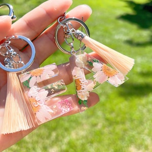 Resin letter keychain with dry flower and Tassel, keychain ring included. Add name with no extra cost.