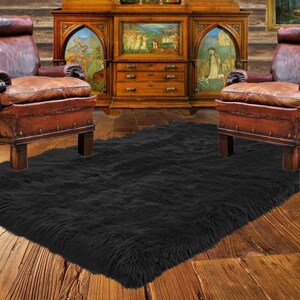 May include: A black faux fur rug with a long pile, placed in front of a wooden cabinet with two chairs on either side.