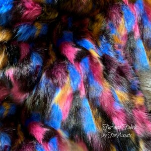 May include: Multicolored faux fur fabric with a geometric pattern in shades of pink, blue, black, and gold. The fabric is soft and fluffy, and it would be perfect for making a variety of crafts, such as blankets, pillows, and clothing.