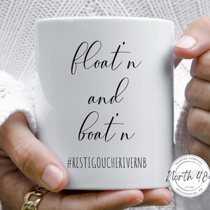May include: White ceramic mug with the words "float'n and boat'n" in black script. Below the text is the hashtag "#RESTIGOUCHERIVERNB". The mug also features the logo of "North 48 Trading Company".