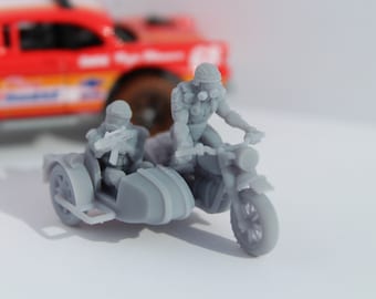 May include: A gray plastic toy motorcycle and sidecar with two figures riding. The figure in the sidecar is holding a gun. The figure driving the motorcycle is wearing a helmet and goggles.