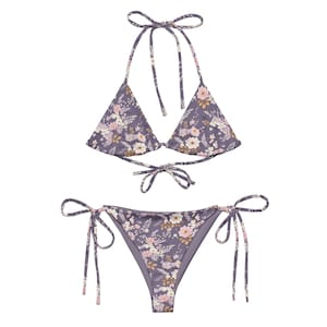 May include: A purple floral print bikini with a triangle top and a tie-side bottom.