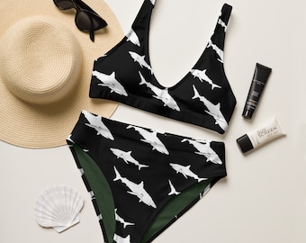 May include: Black and green bikini with a shark print. The bikini top has a scoop neck and adjustable straps. The bikini bottom has a high waist and full coverage.
