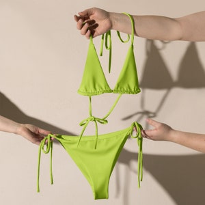 May include: A lime green bikini top and bottom with adjustable straps. The top is a triangle style and the bottom is a cheeky style.